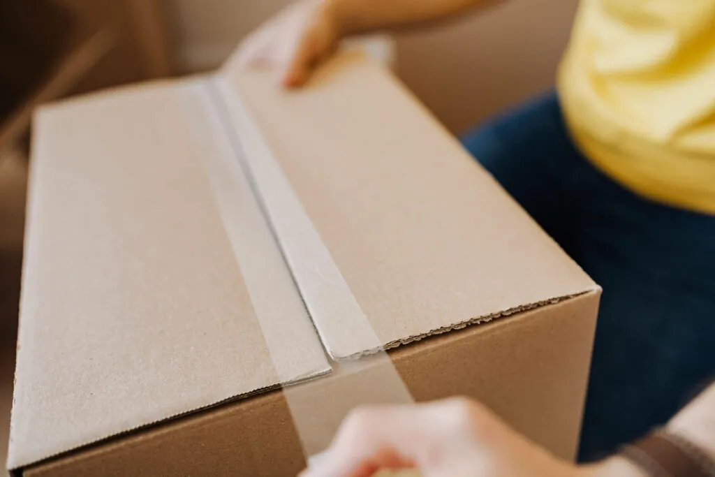 Courier loading parcels into a delivery vehicle