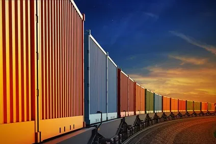 Freight train on tracks through the landscape